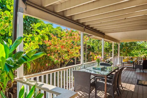 a view of balcony with furniture and wooden deck