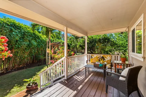 a view of balcony with chairs and wooden floor