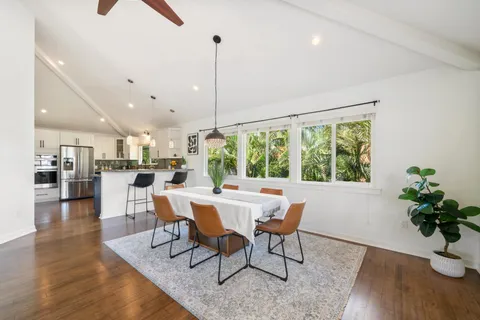 a dining room with furniture window and wooden floor