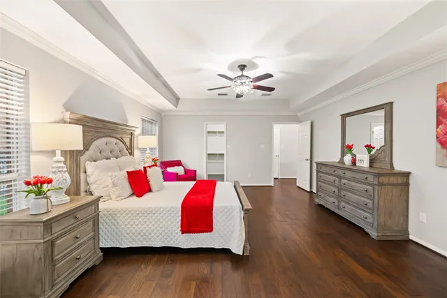 a spacious bedroom with a bed and a chandelier