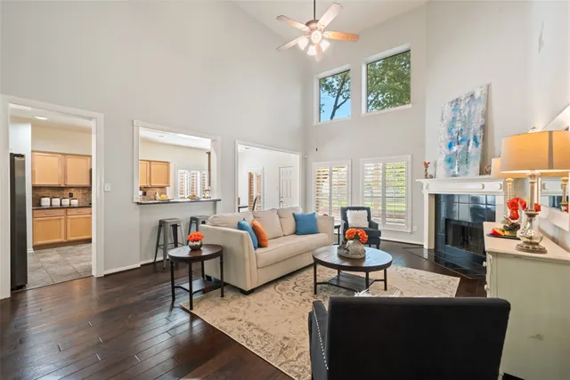 a living room with fireplace furniture and a wooden floor