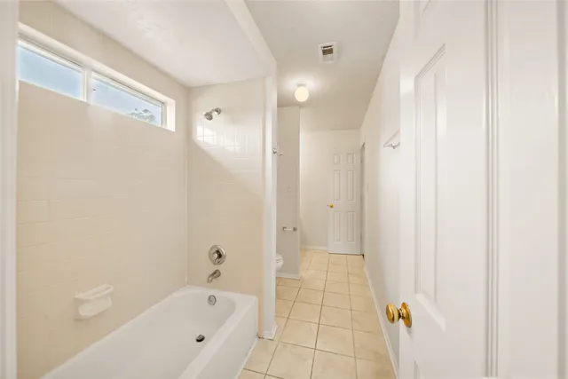 a view of a house with a yard and large tree