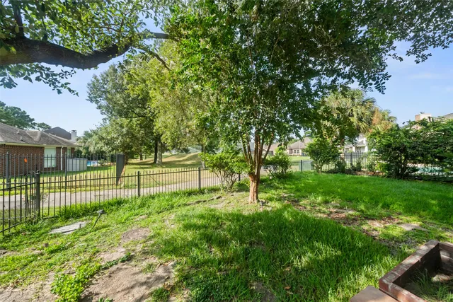 a view of a house with a yard and sitting area