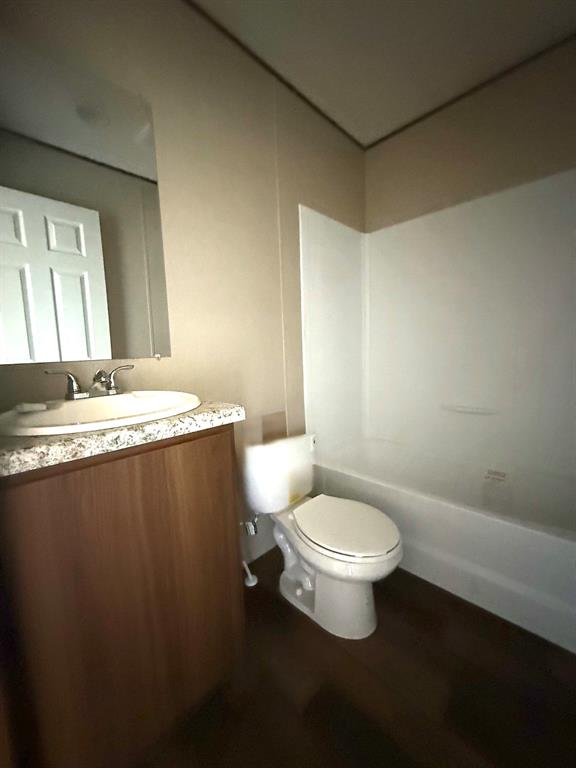 0 Southeast 4060 Road, Unit 25 Kerens, TX 75144 - Photo 14 of 18 Bathroom featuring a white bathtub, toilet, and a vanity with a white basin sink
