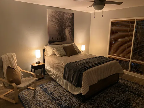 a bedroom with bed and chair