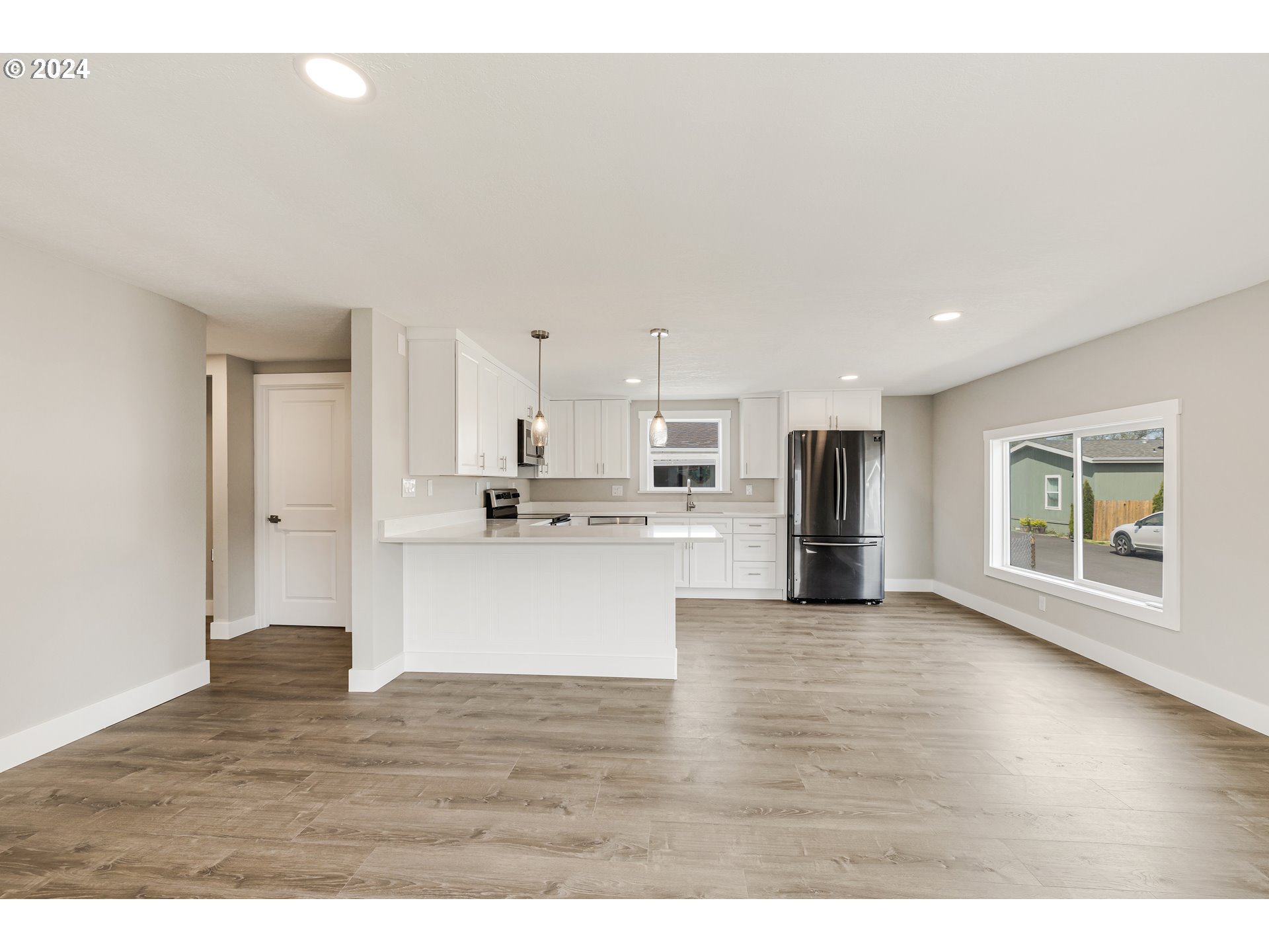 32968 Southwest Plum Tree Court Cornelius, OR 97113 - Photo 12 of 30 a view of kitchen with stainless steel appliances granite countertop a stove top oven a refrigerator a sink with wooden floors