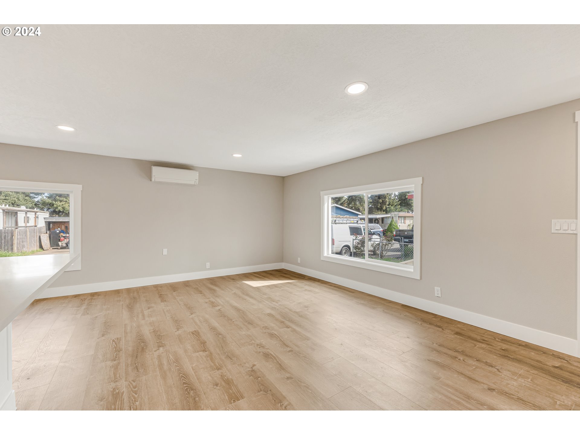 32968 Southwest Plum Tree Court Cornelius, OR 97113 - Photo 10 of 30 a view of an empty room with a window and wooden floor