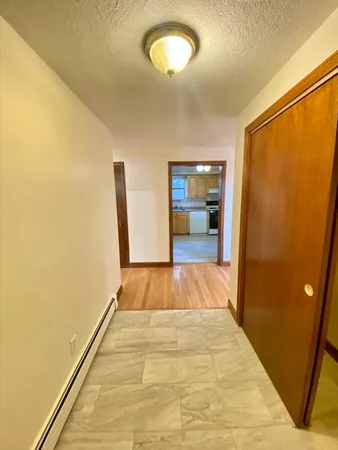 a view of a room with wooden floor and a window
