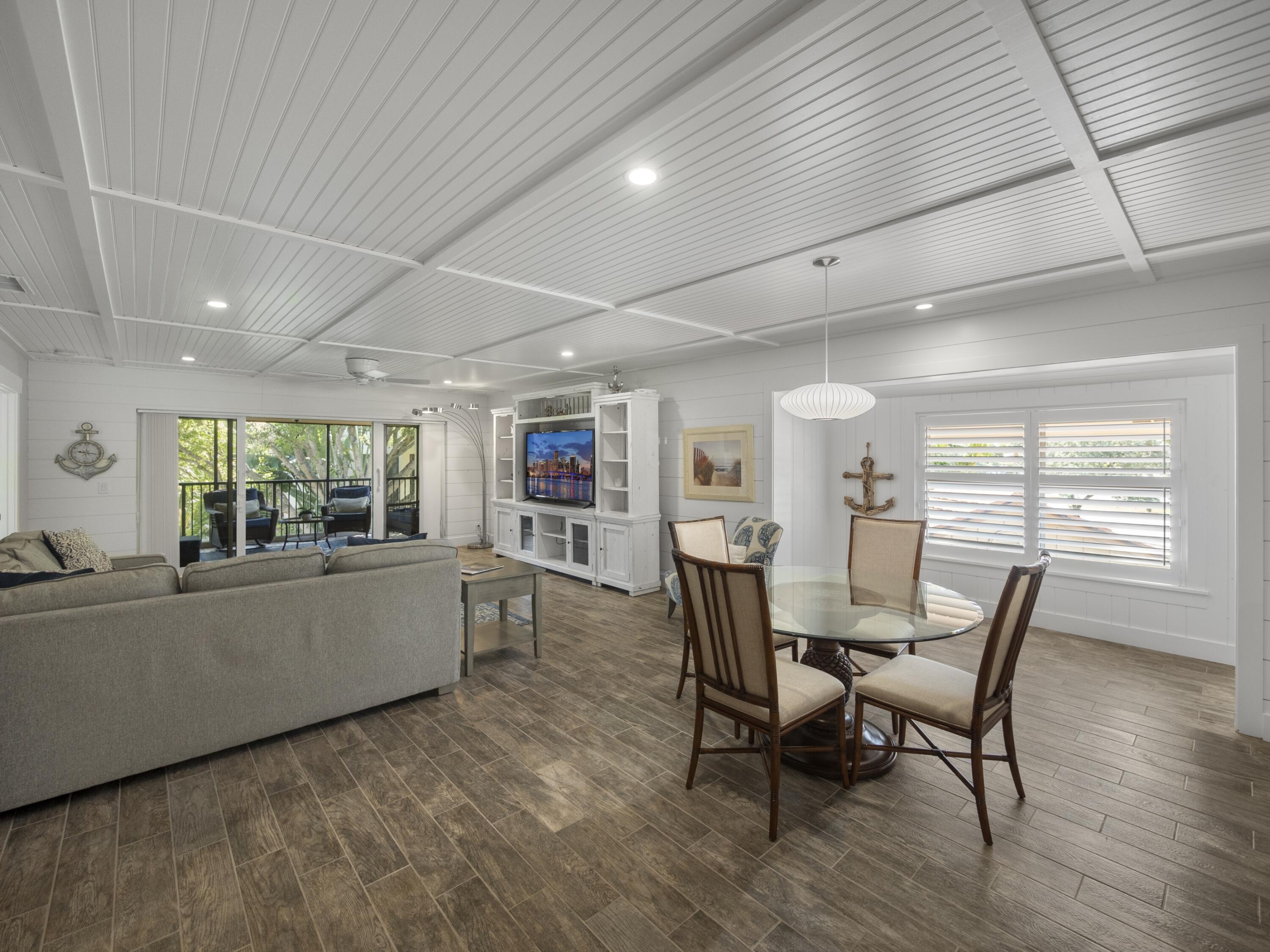 4161 U.S. Highway 1, Unit C3 Jupiter, FL 33477 - Photo 12 of 34 a living room with furniture and a large window