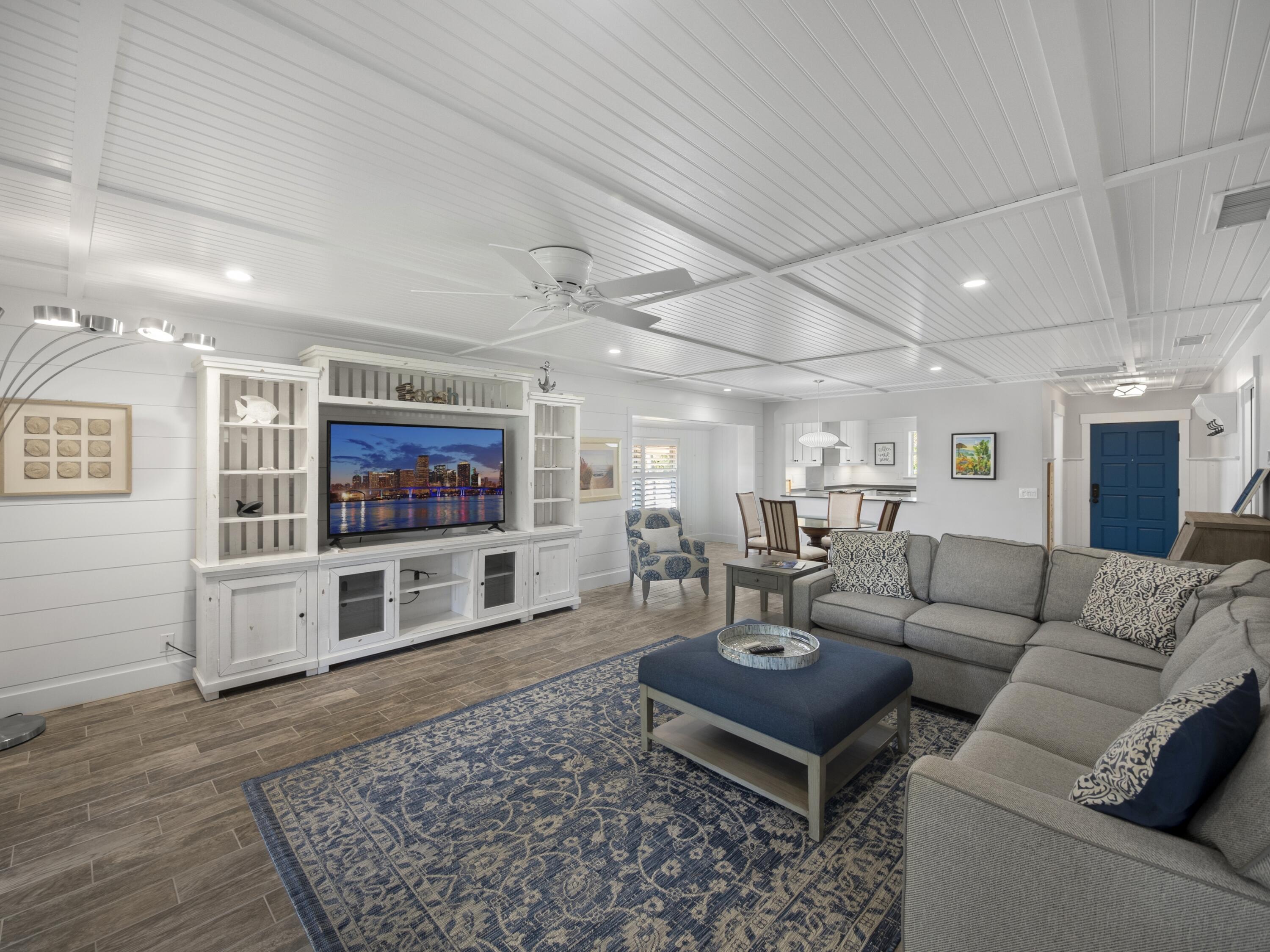 4161 U.S. Highway 1, Unit C3 Jupiter, FL 33477 - Photo 13 of 34 a living room with furniture and a flat screen tv