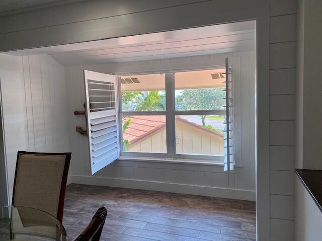 4161 U.S. Highway 1, Unit C3 Jupiter, FL 33477 - Photo 14 of 34 a view of an empty room with wooden floor and a window