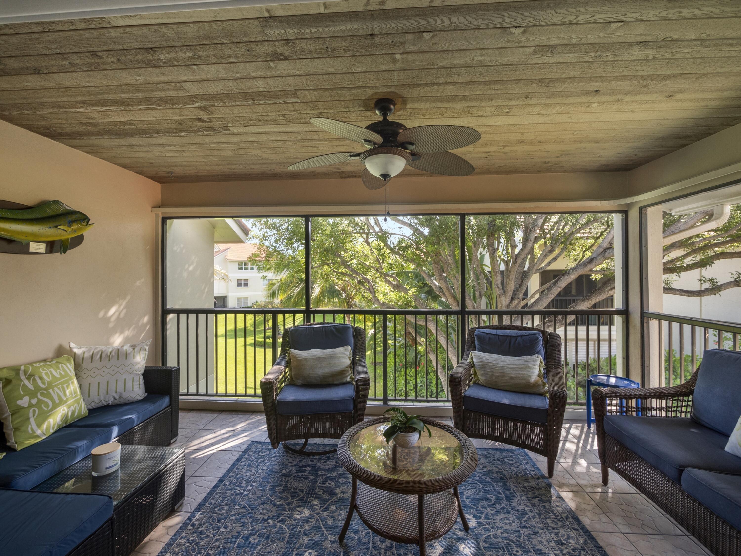 4161 U.S. Highway 1, Unit C3 Jupiter, FL 33477 - Photo 19 of 34 a living room with furniture and a floor to ceiling window