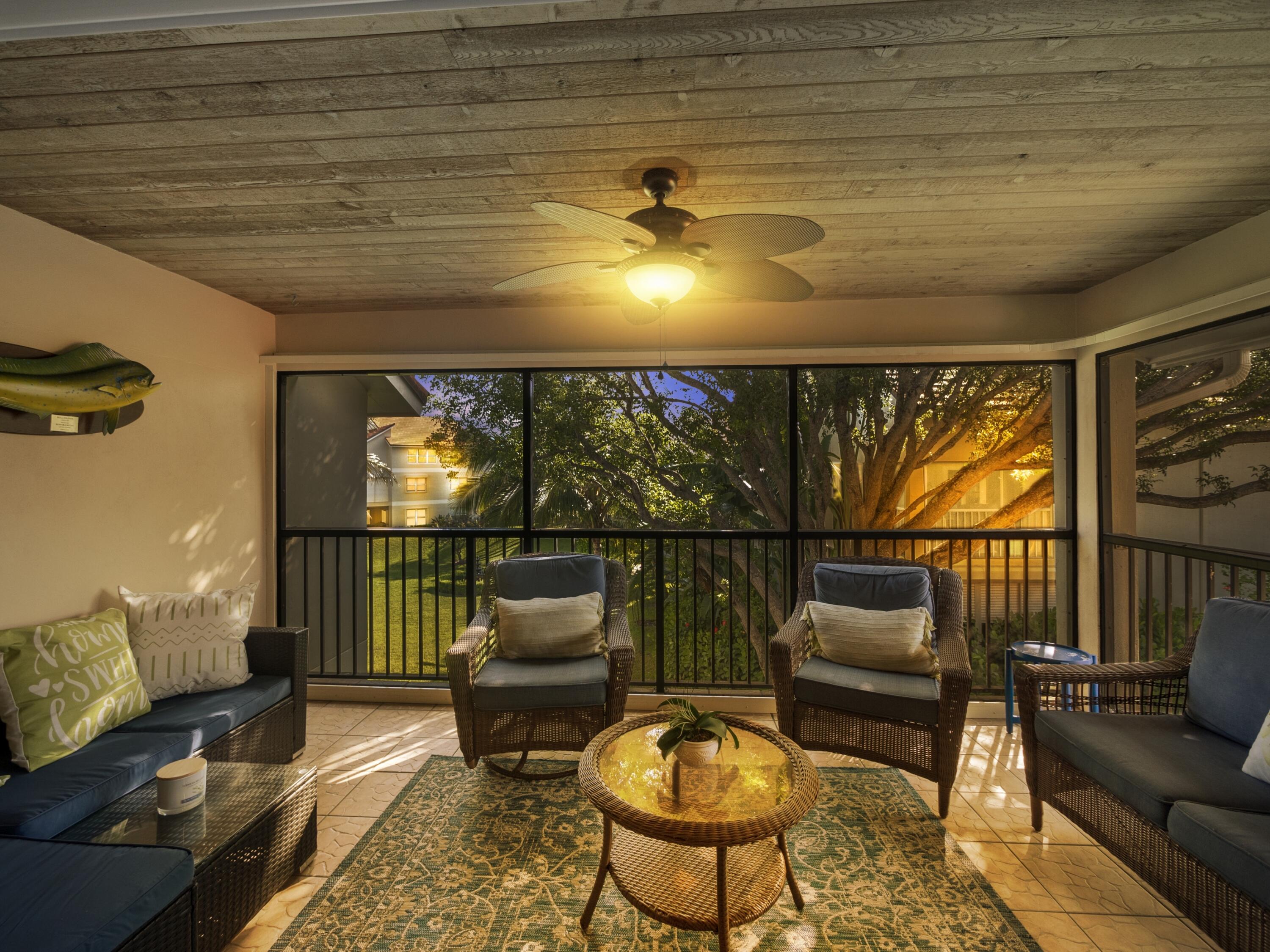 4161 U.S. Highway 1, Unit C3 Jupiter, FL 33477 - Photo 21 of 34 a living room with furniture and a flat screen tv