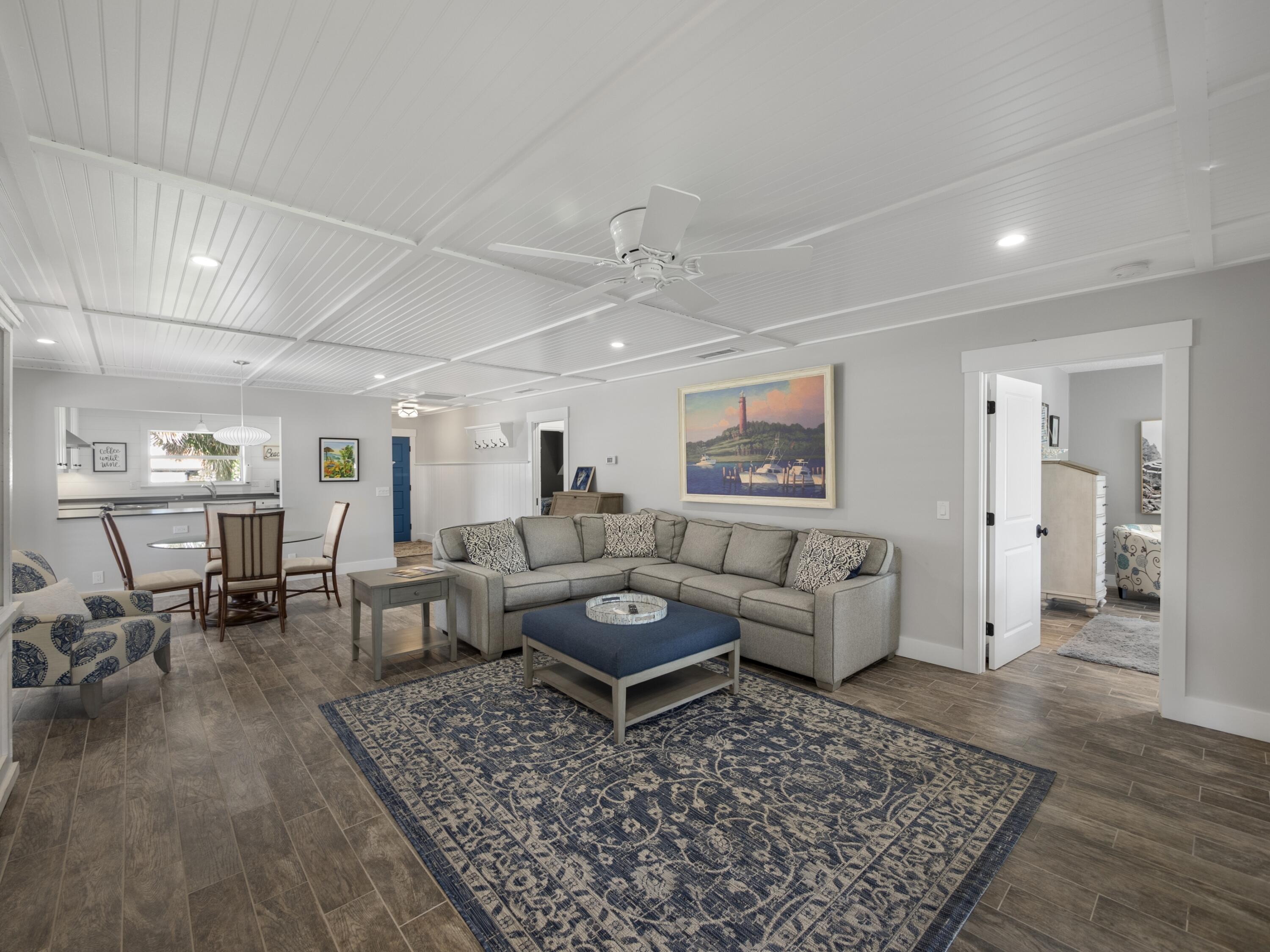 4161 U.S. Highway 1, Unit C3 Jupiter, FL 33477 - Photo 7 of 34 a living room with furniture and wooden floor