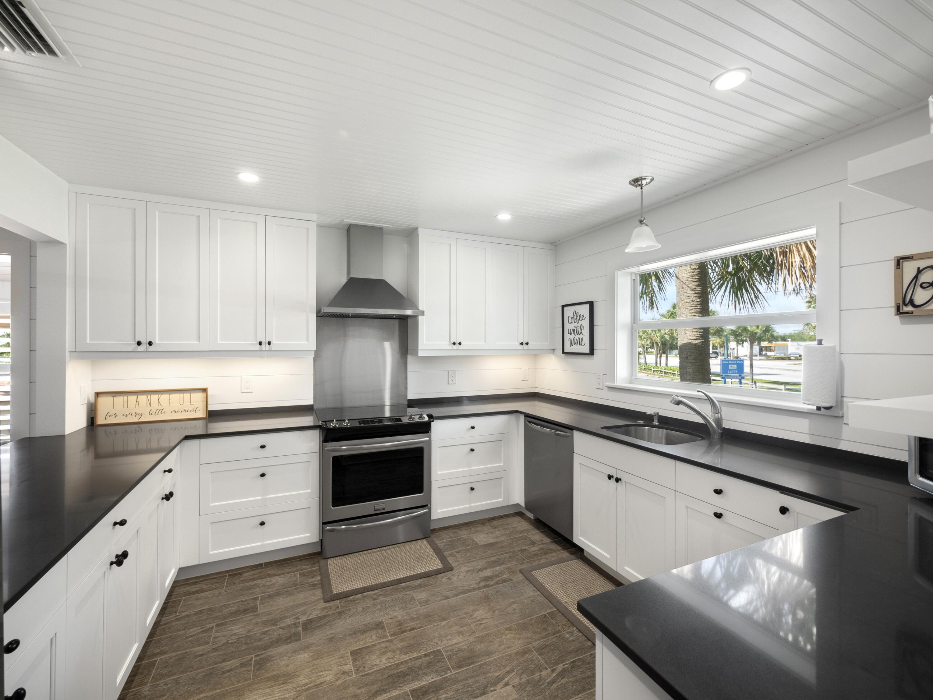 4161 U.S. Highway 1, Unit C3 Jupiter, FL 33477 - Photo 10 of 34 a kitchen with granite countertop white cabinets and white appliances