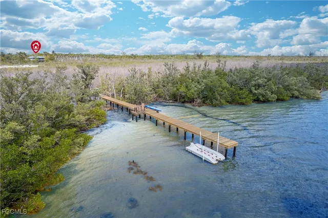a aerial view of a house with yard and outdoor seating