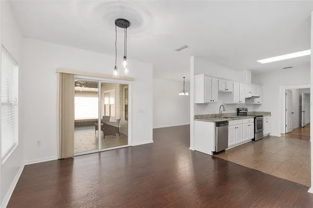 a view of a kitchen with wooden floor and a kitchen