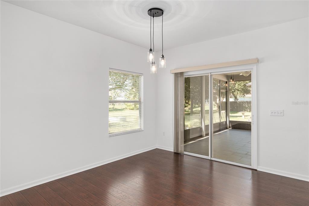 7982 Southwest 83rd Terrace Gainesville, FL 32608 - Photo 13 of 53 a view of an empty room with wooden floor and a window