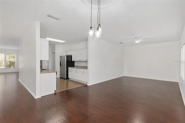 a kitchen with granite countertop white cabinets and stainless steel appliances