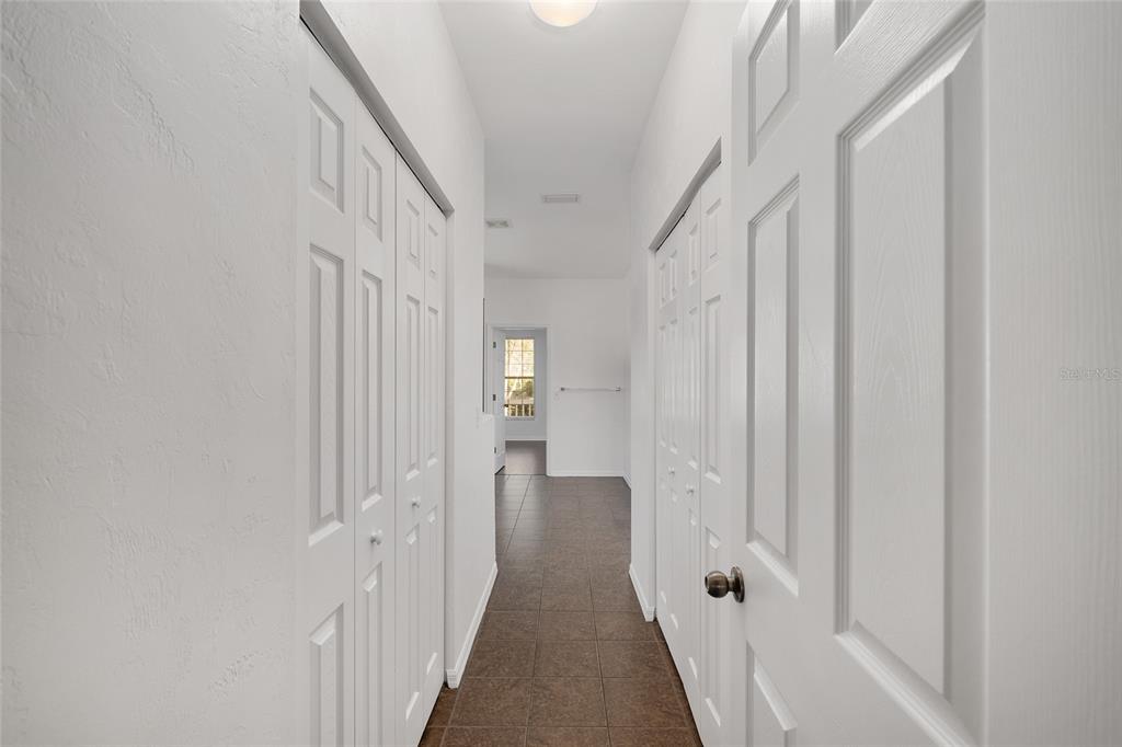 7982 Southwest 83rd Terrace Gainesville, FL 32608 - Photo 24 of 53 a view of a hallway with wooden floor and staircase