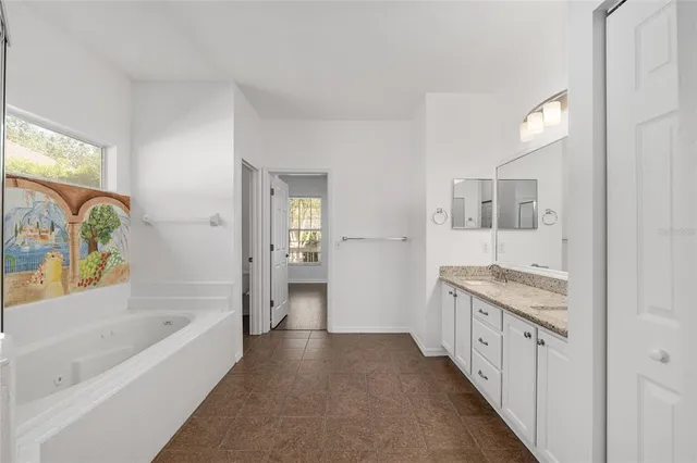 a bathroom with a granite countertop sink a large mirror and shower