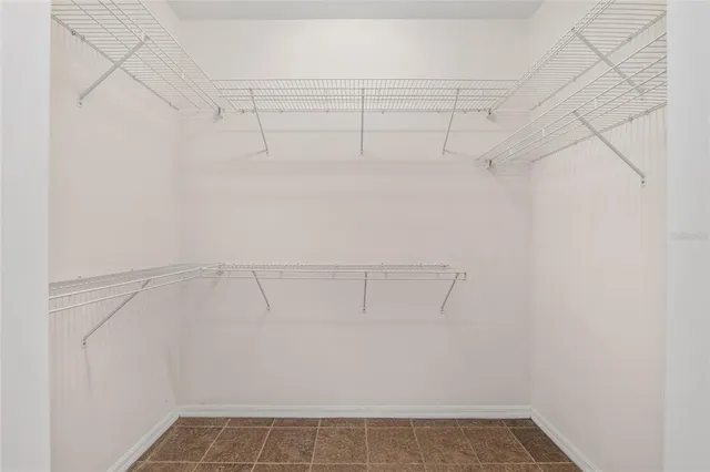 a bathroom with a granite countertop tub a sink and a shower