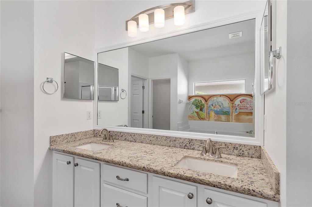 7982 Southwest 83rd Terrace Gainesville, FL 32608 - Photo 28 of 53 a bathroom with a granite countertop sink and a mirror