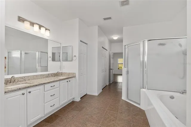 a bathroom with a glass shower door