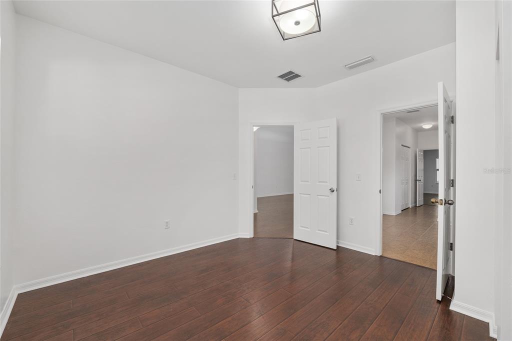 7982 Southwest 83rd Terrace Gainesville, FL 32608 - Photo 33 of 53 an empty room with wooden floor and windows
