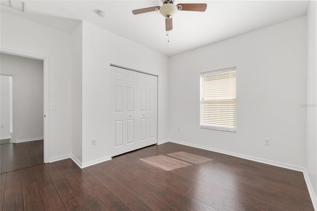 7982 Southwest 83rd Terrace Gainesville, FL 32608 - Photo 37 of 53 an empty room with wooden floor and windows