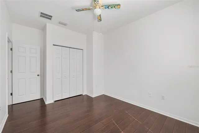 a view of an empty room with furniture and a large window