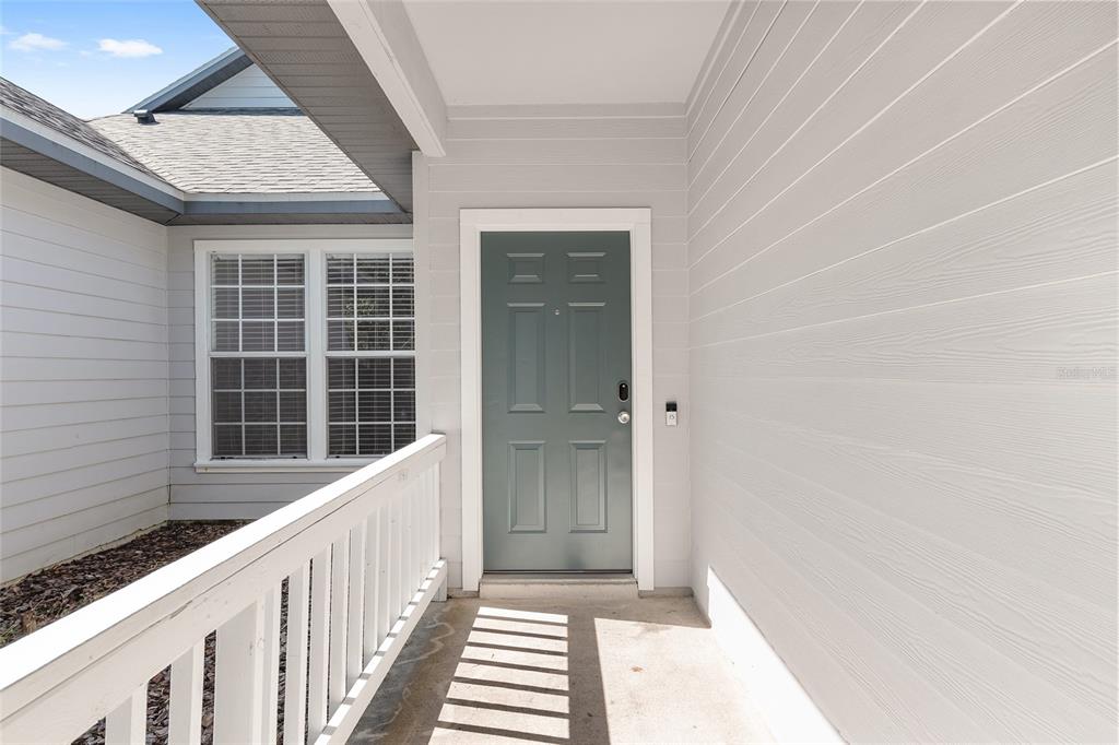 7982 Southwest 83rd Terrace Gainesville, FL 32608 - Photo 5 of 53 a view of a porch with wooden floor and a window
