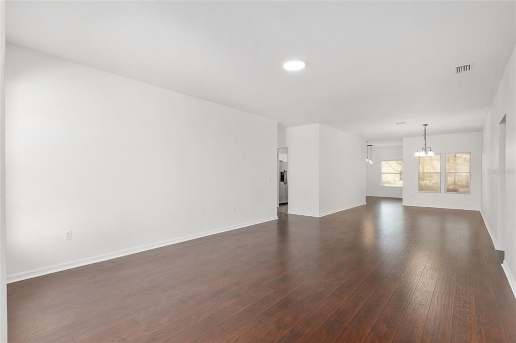 7982 Southwest 83rd Terrace Gainesville, FL 32608 - Photo 8 of 53 a view of an empty room with wooden floor