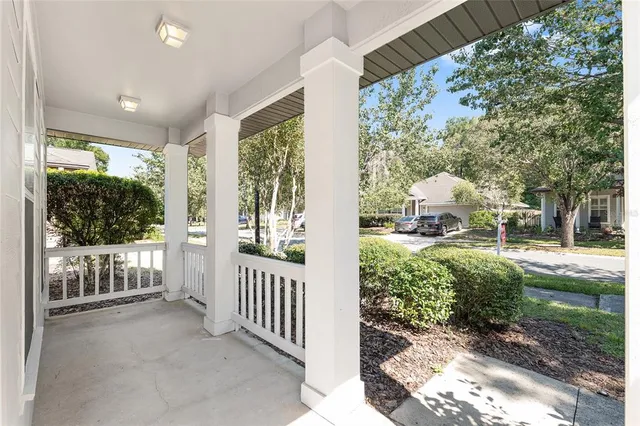 a view of a porch with wooden floor and a window