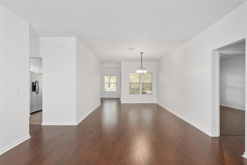 7982 Southwest 83rd Terrace Gainesville, FL 32608 - Photo 9 of 53 an empty room with wooden floor and window