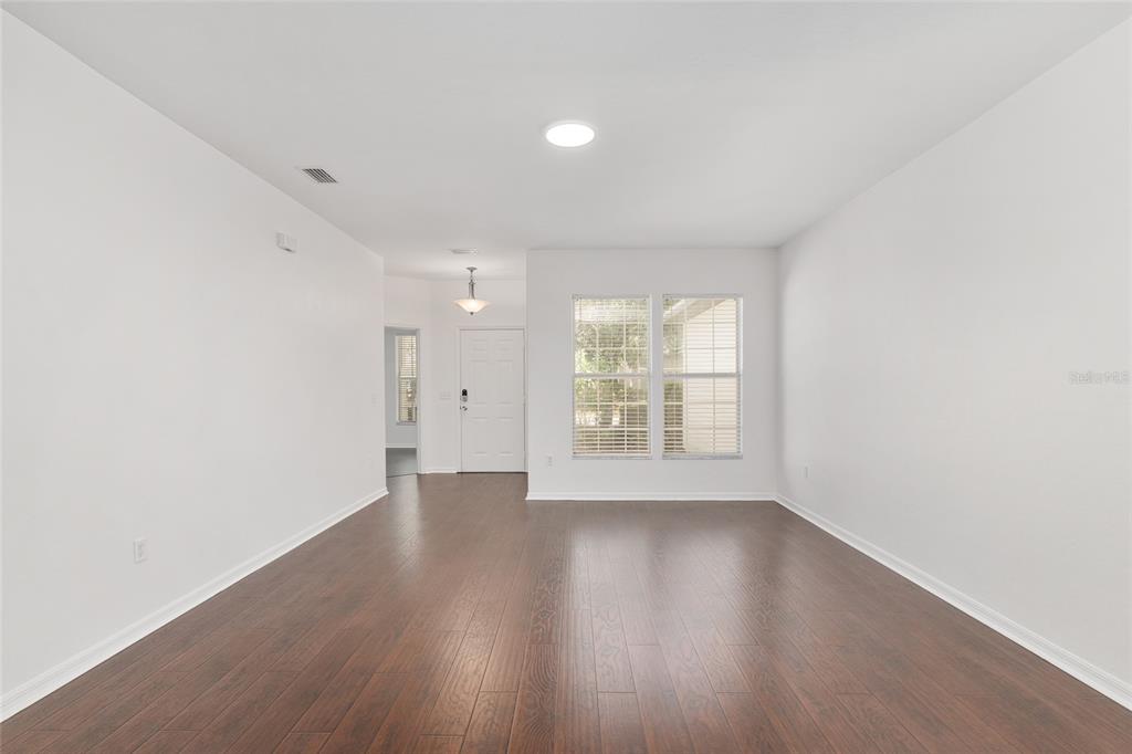 7982 Southwest 83rd Terrace Gainesville, FL 32608 - Photo 10 of 53 an empty room with wooden floor and windows