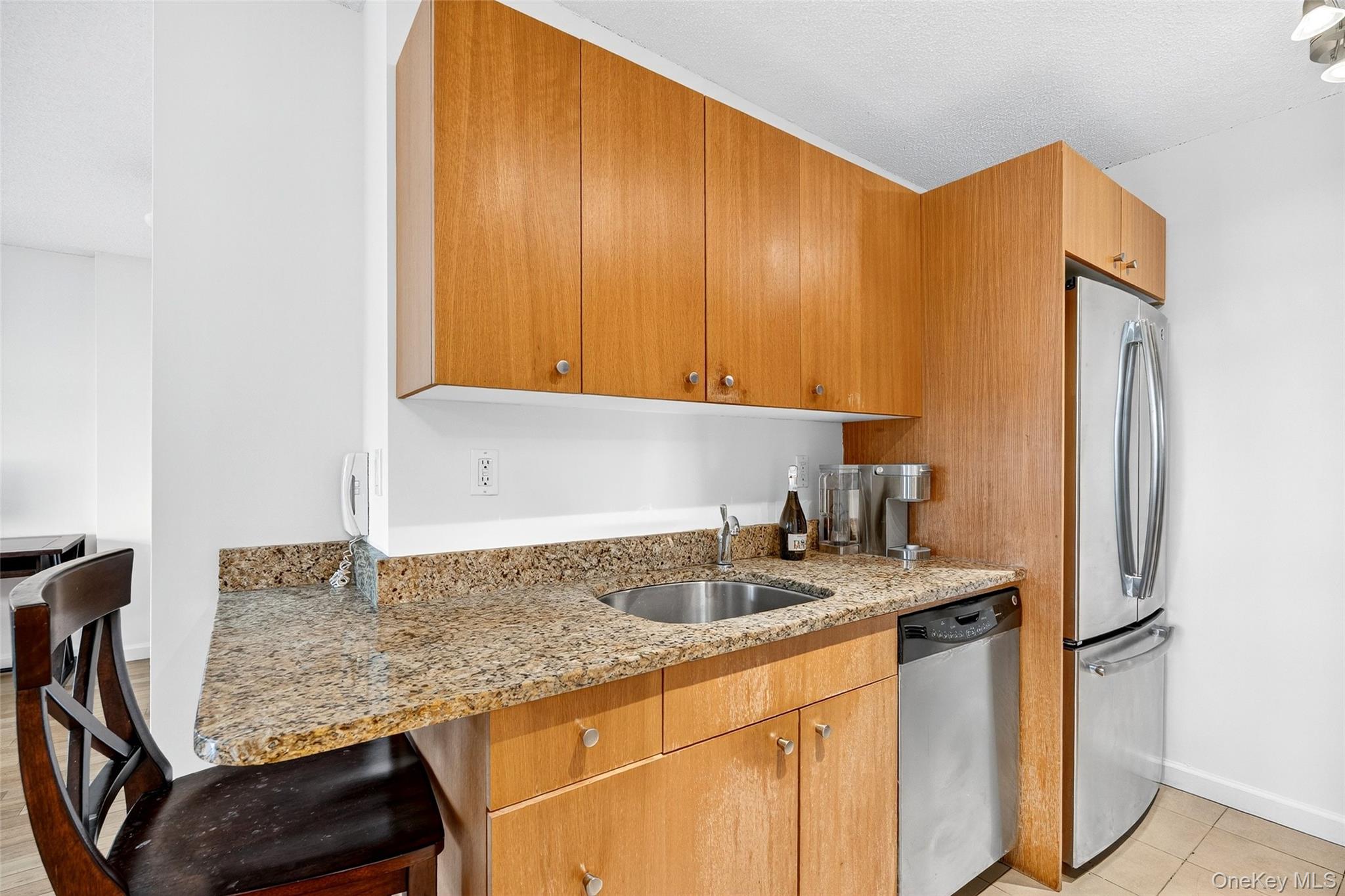2287 Johnson Avenue, Unit 10B Bronx, NY 10463 - Photo 6 of 27 a kitchen with stainless steel appliances granite countertop a sink refrigerator and cabinets