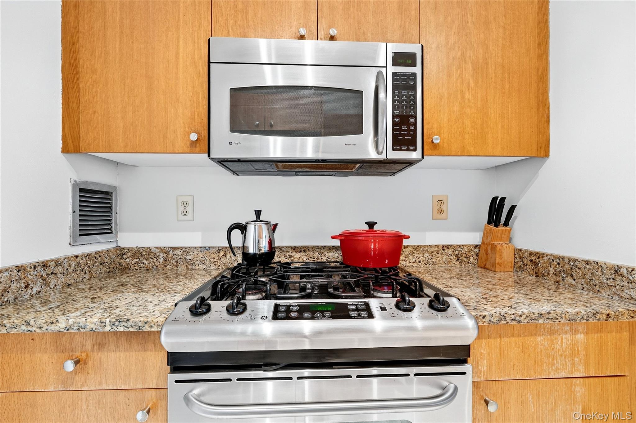 2287 Johnson Avenue, Unit 10B Bronx, NY 10463 - Photo 8 of 27 a kitchen with stainless steel appliances granite countertop a stove and a microwave