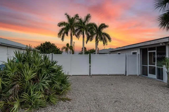 front view of house with potted plant and a yard