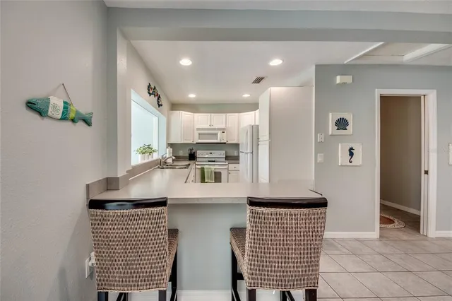 a kitchen with a sink appliances and cabinets