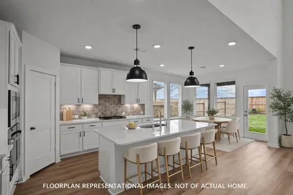 a kitchen with stainless steel appliances kitchen island granite countertop a sink and refrigerator