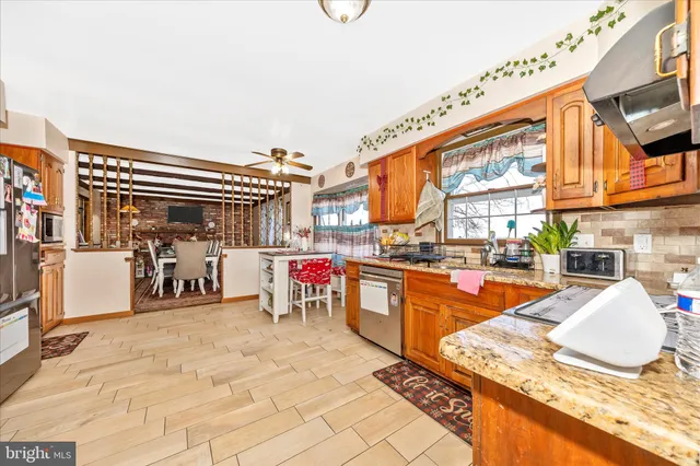 a kitchen with stainless steel appliances granite countertop a stove and cabinets