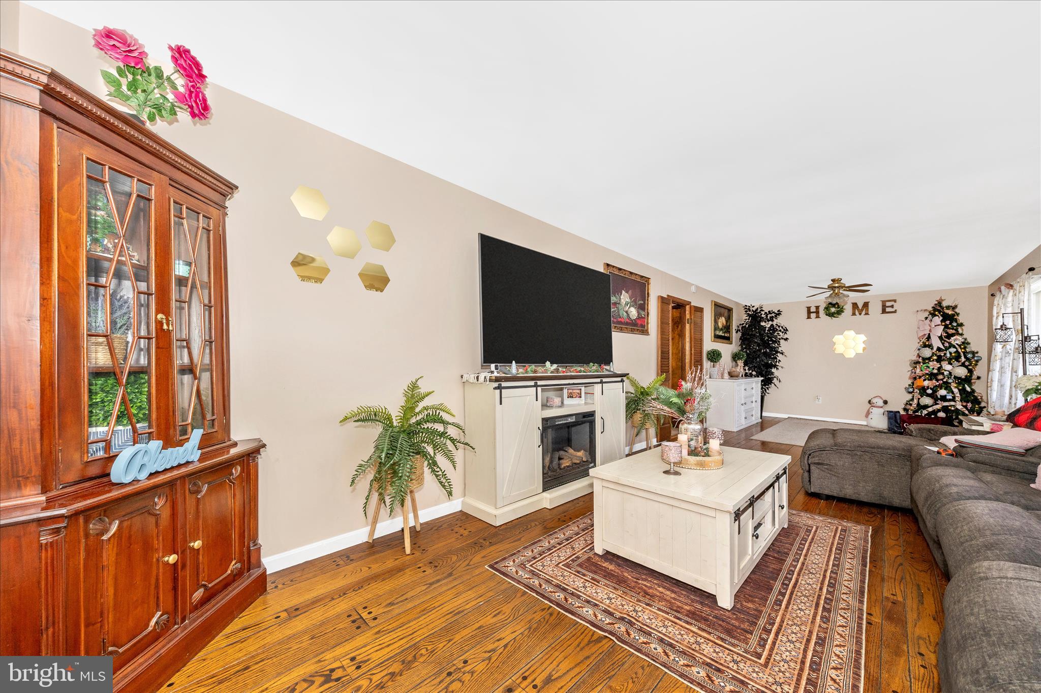 25801 Long Corner Road Gaithersburg, MD 20882 - Photo 21 of 52 a living room with furniture a flat screen tv and a floor to ceiling window