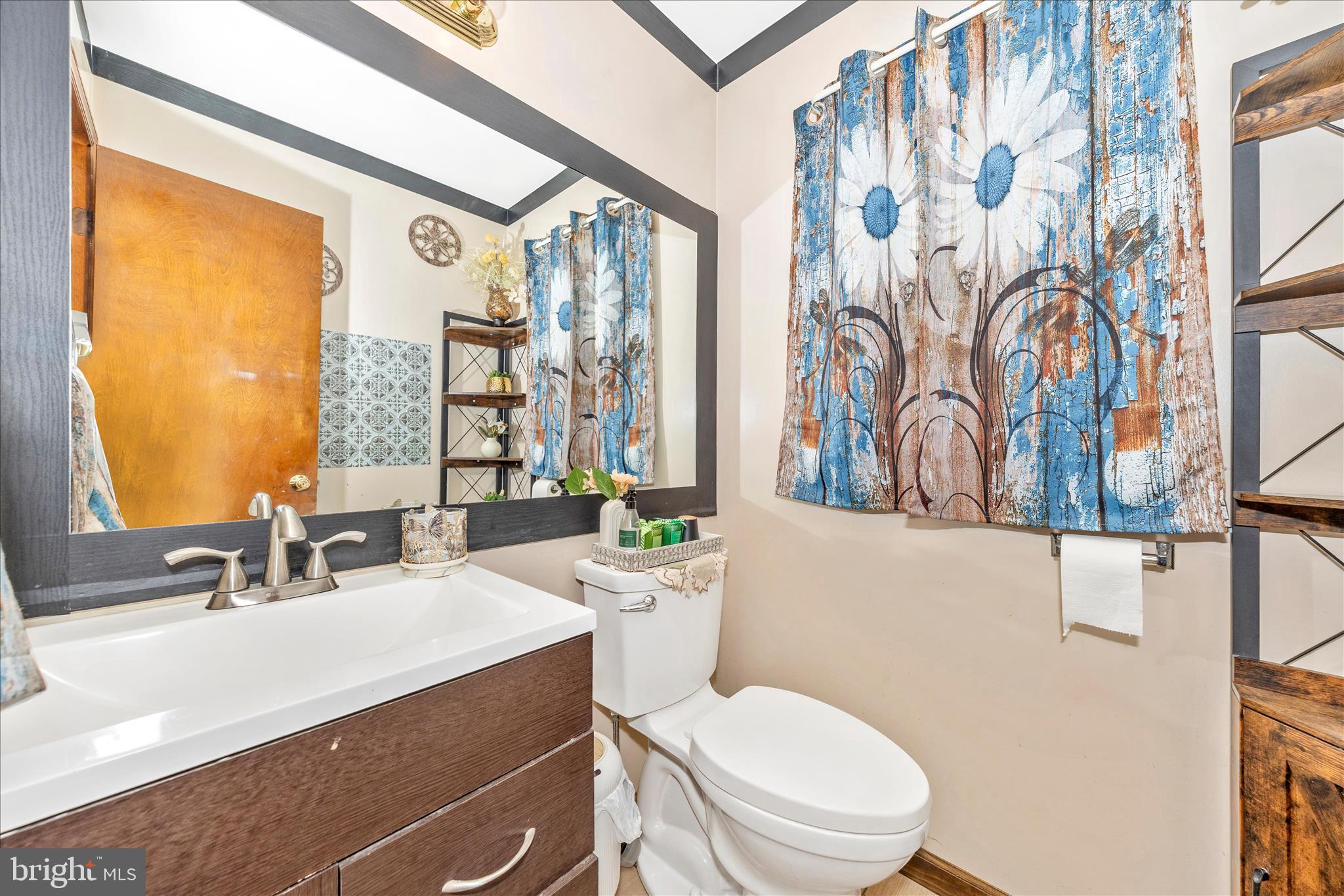 25801 Long Corner Road Gaithersburg, MD 20882 - Photo 24 of 52 a bathroom with a sink a mirror a toilet and a window