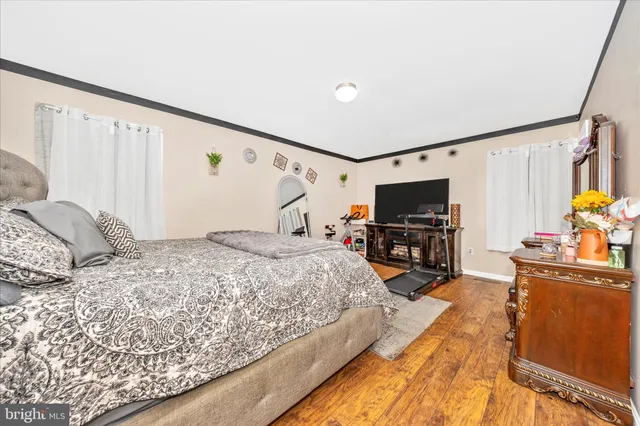 a bedroom with furniture and a flat screen tv