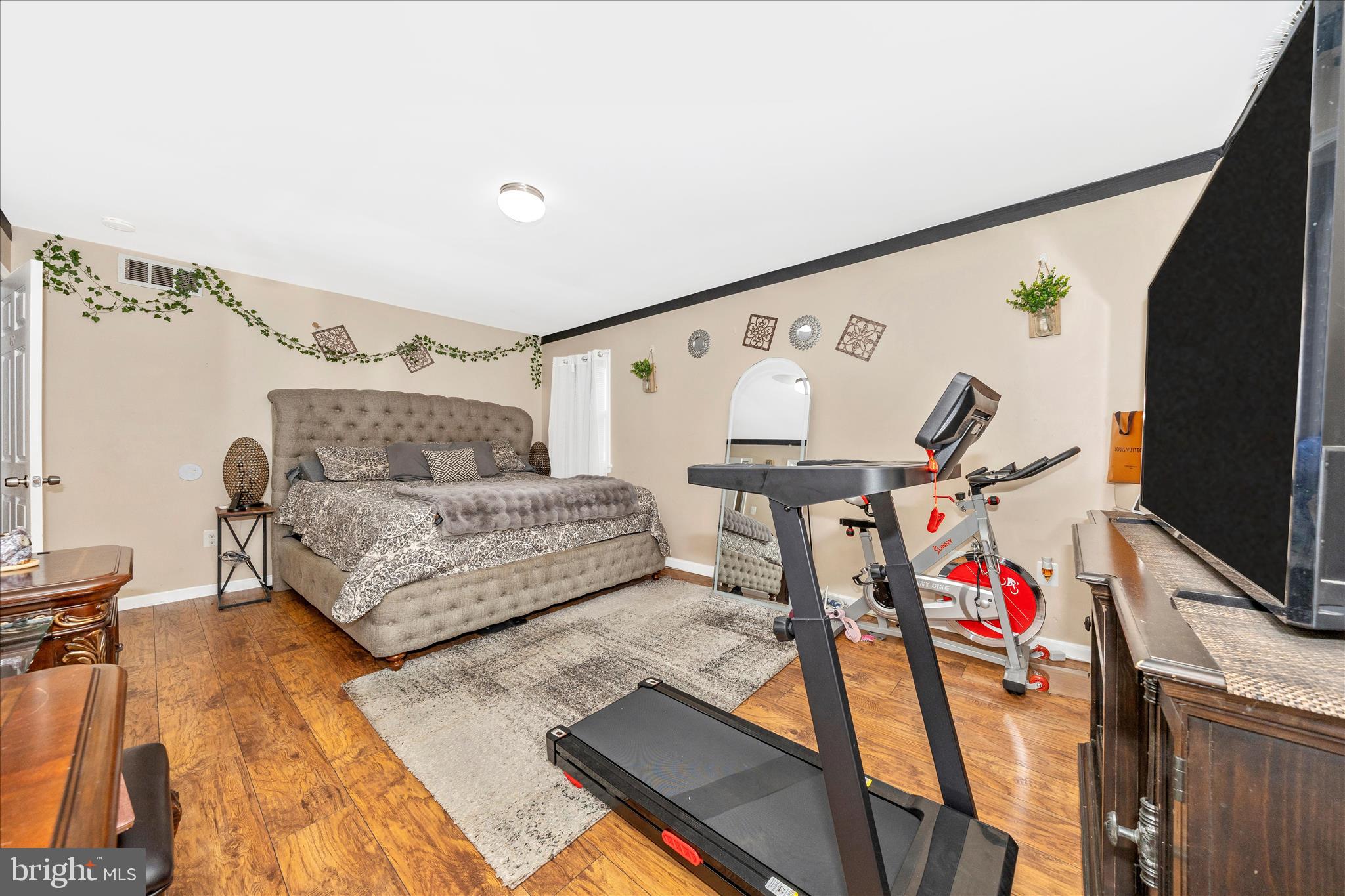 25801 Long Corner Road Gaithersburg, MD 20882 - Photo 36 of 52 a bedroom with furniture and a flat screen tv