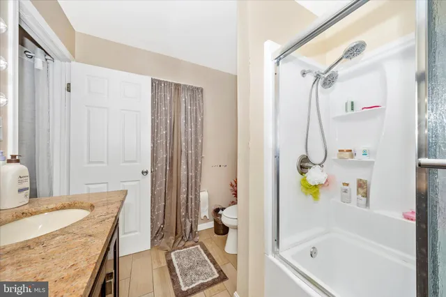 a living room with furniture and a dining table