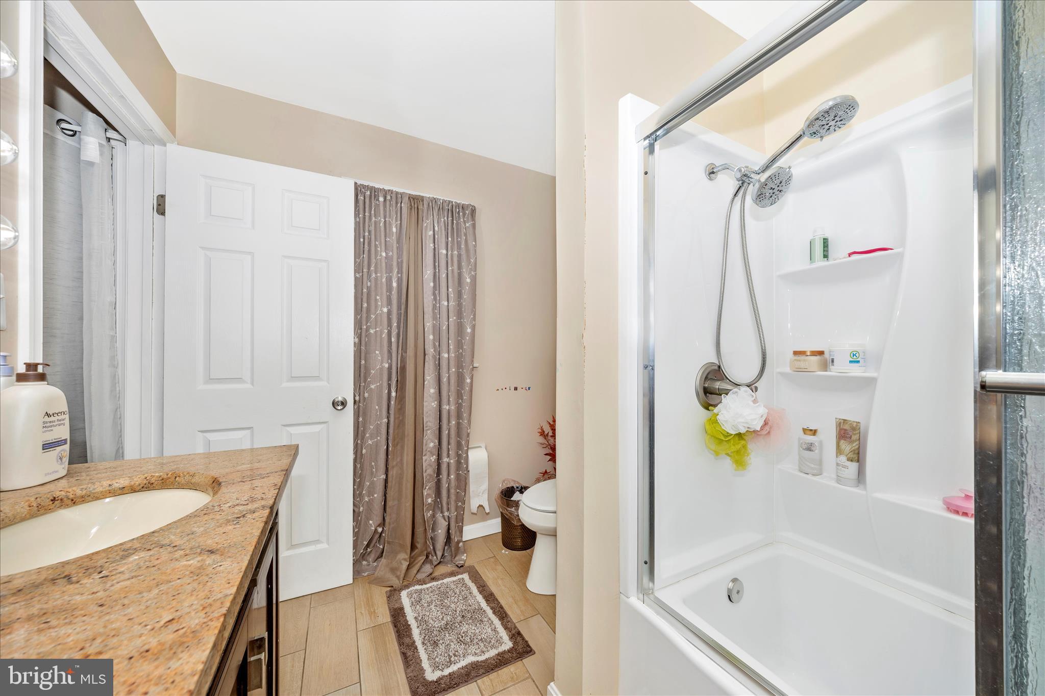 25801 Long Corner Road Gaithersburg, MD 20882 - Photo 39 of 52 a bathroom with a tub a sink and a shower