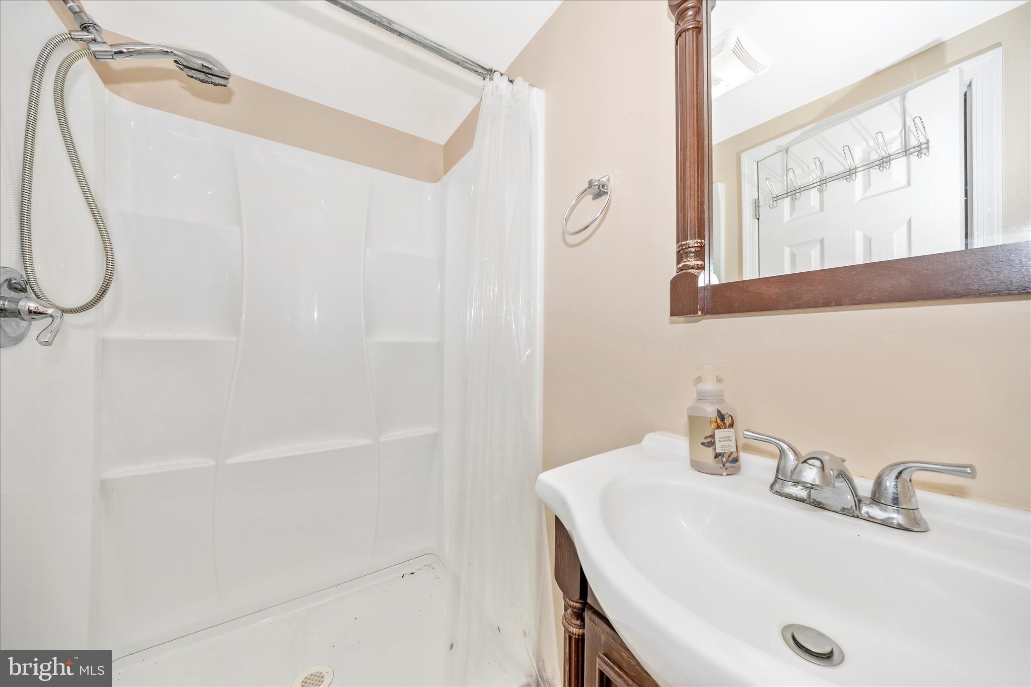 25801 Long Corner Road Gaithersburg, MD 20882 - Photo 44 of 52 a bathroom with a sink and a mirror
