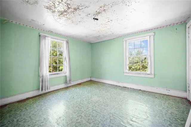 an empty room with a ceiling fan